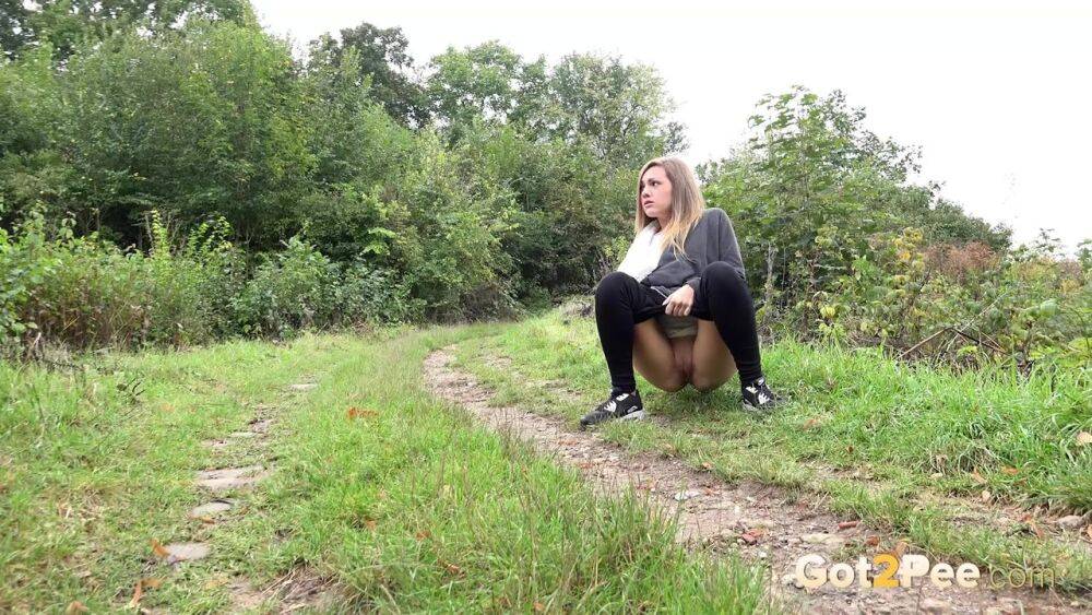 White girl is captured on hidden camera taking a piss in someone's garden - #3