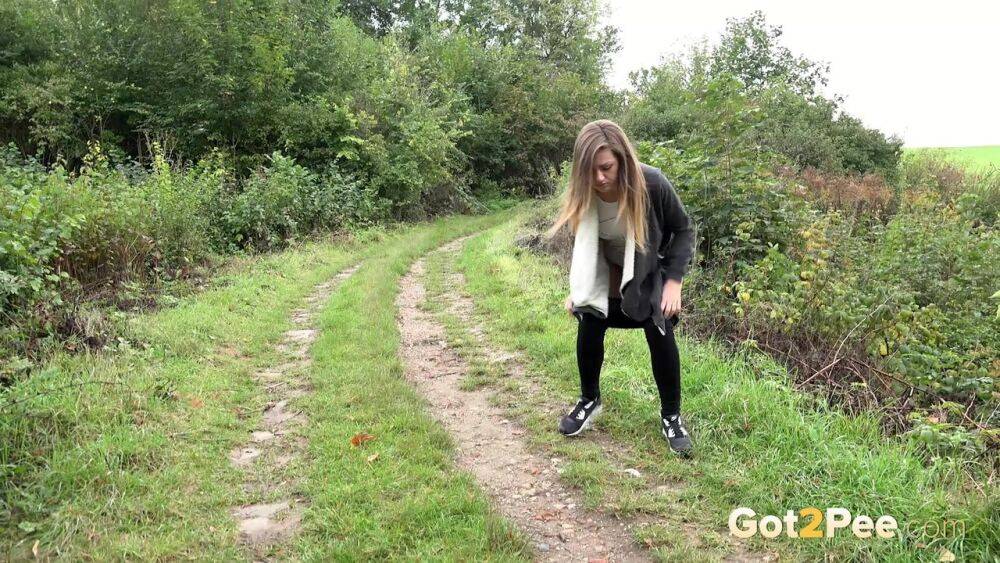 White girl is captured on hidden camera taking a piss in someone's garden - #6