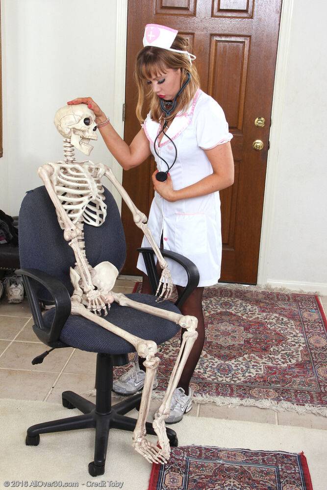 Sexy nurse Christy James peels her white uniform to facesit on a skeleton - #5