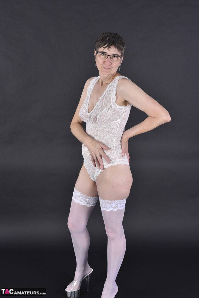 Older amateur removes her robe to model in the white lace lingerie & stockings - #12