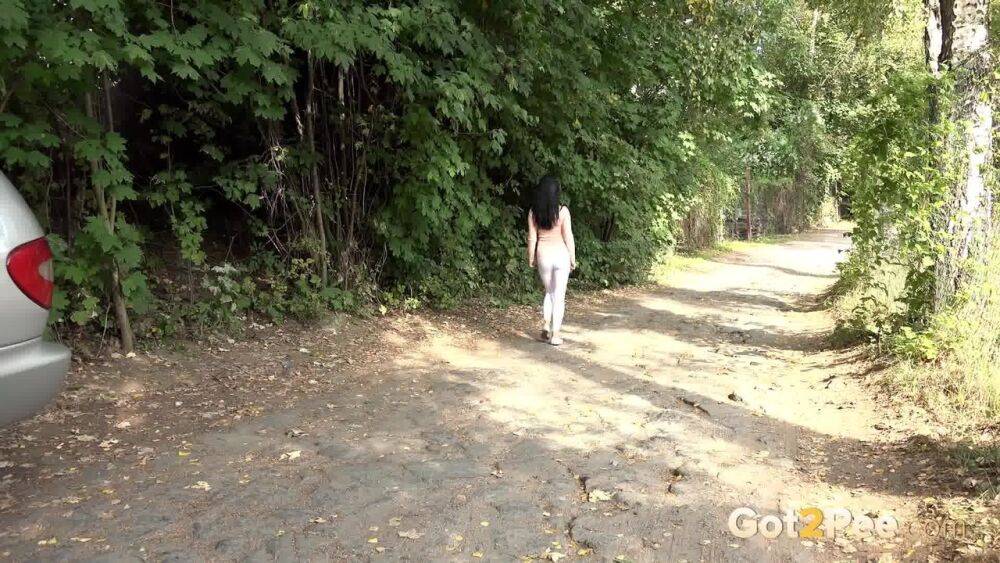 Dark haired girl Dee pulls down her white leggings for quick pee behind bushes - #4