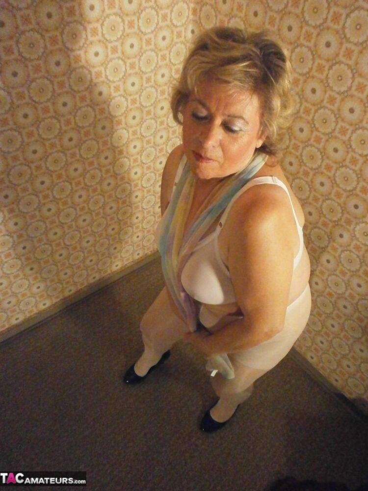 Big ass mature lady Caro posing in white pantyhose and black high heels - #16