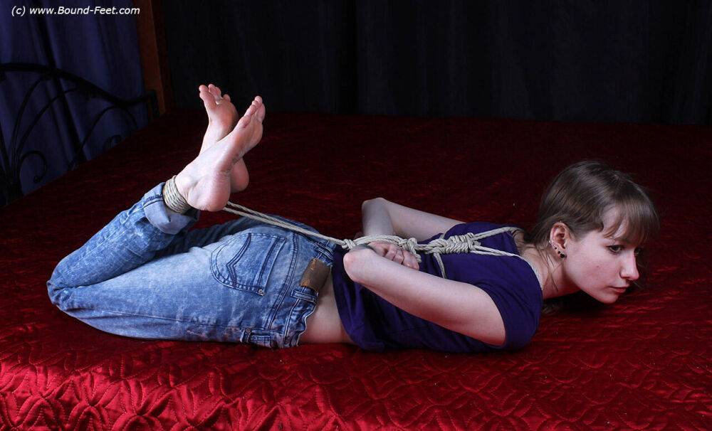 Barefoot white girl Agnes is hogtied in a shirt and blue jeans - #15