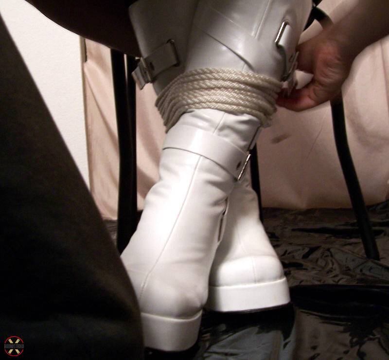 Solo model is tied up with rope while fully clothed in white boots - #4