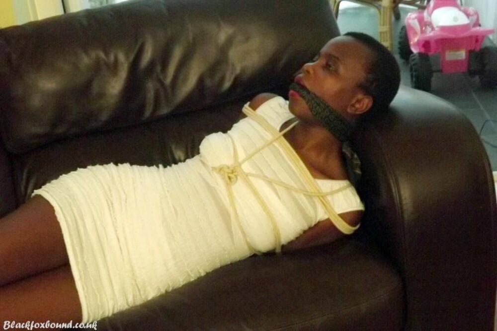 Black female is left tied and cleave gagged in a white dress on a leather sofa - #15