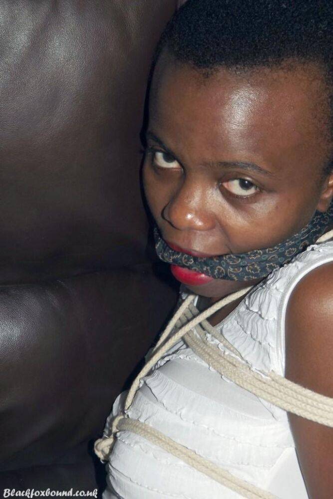 Black female is left tied and cleave gagged in a white dress on a leather sofa - #14