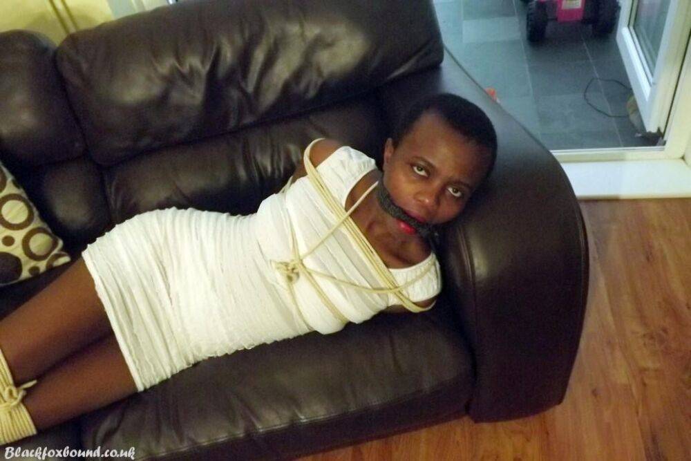 Black female is left tied and cleave gagged in a white dress on a leather sofa - #5