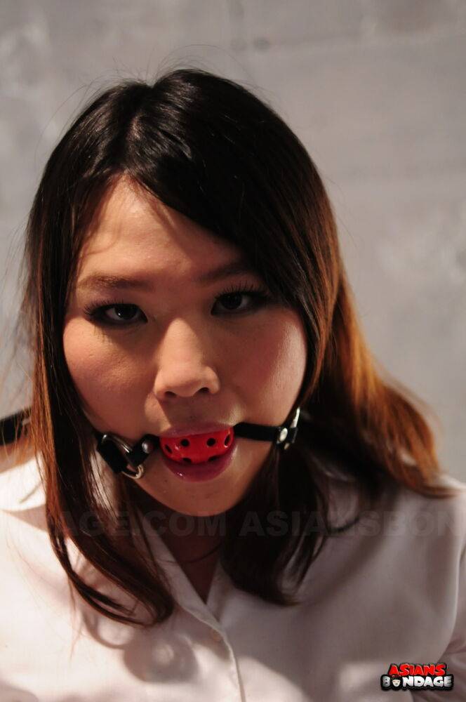 Asian chick Aki Sasahara is fitted with gag in white blouse and black skirt - #12