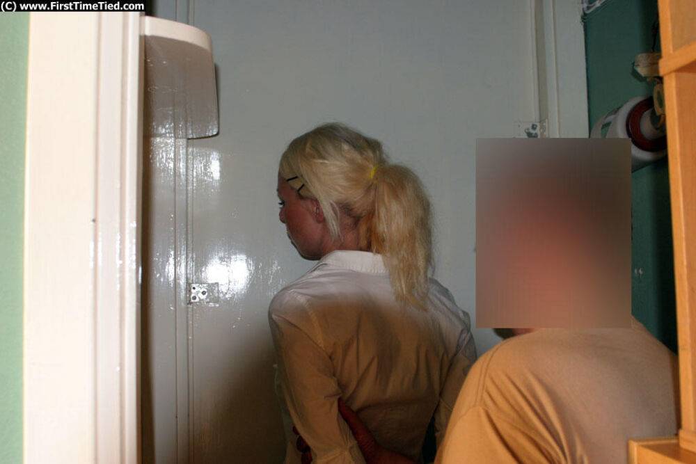 Blonde girl in a black skirt and white blouse is placed in handcuffs - #6