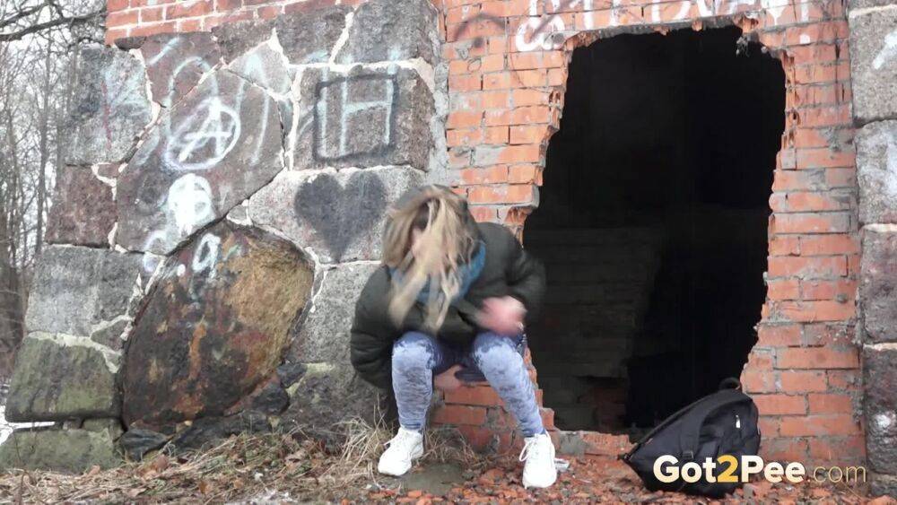 White girl pulls down her jeans for a badly needed pee on snow-covered ground - #3