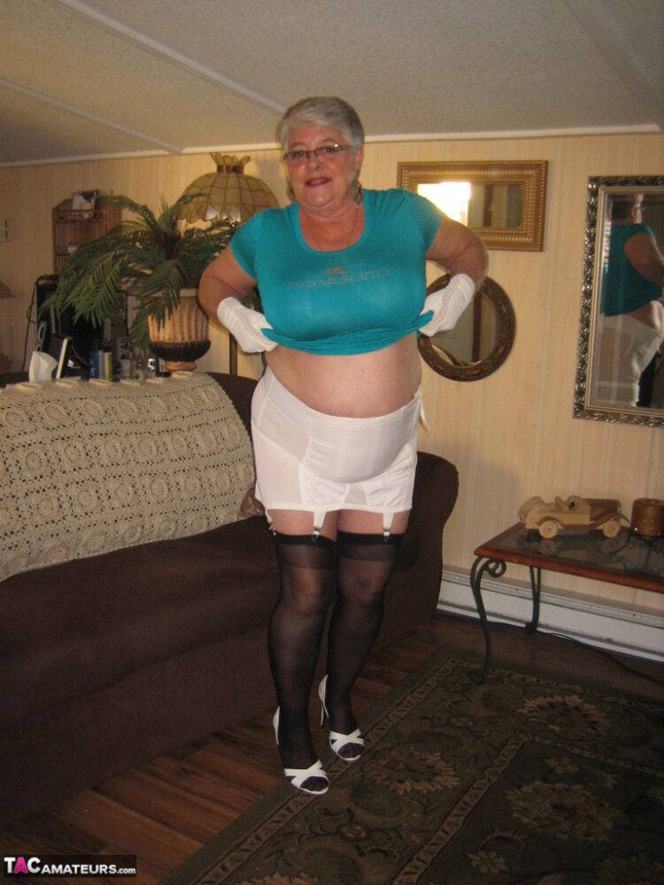 Fat Oma Girdle Goddess wears white gloves while disrobing to a bra and girdle - #10