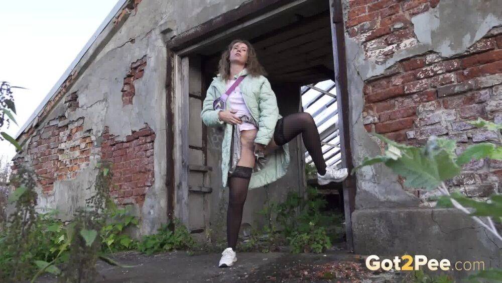 White girl Rita takes a piss by an abandoned building while taking a shortcut - #1