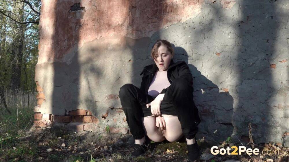 White girl Alexa ducks behind a structure in the woods for a quick piss - #11