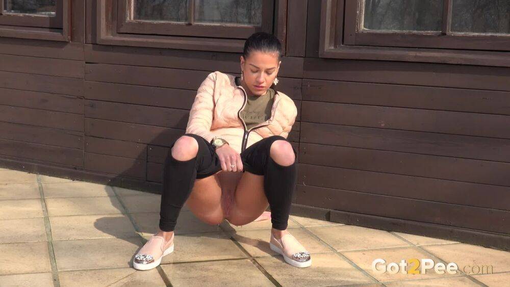 White girl squats for an urgent piss on tiled flooring outside a building - #13