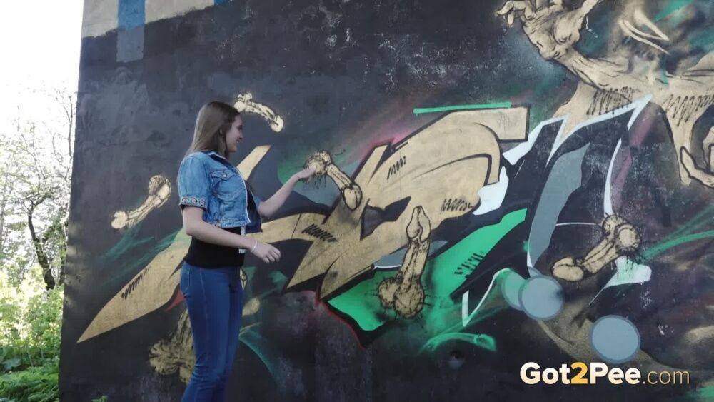 White girl Viktoria pulls down her jeans to take a pee near a wall of graffiti - #8