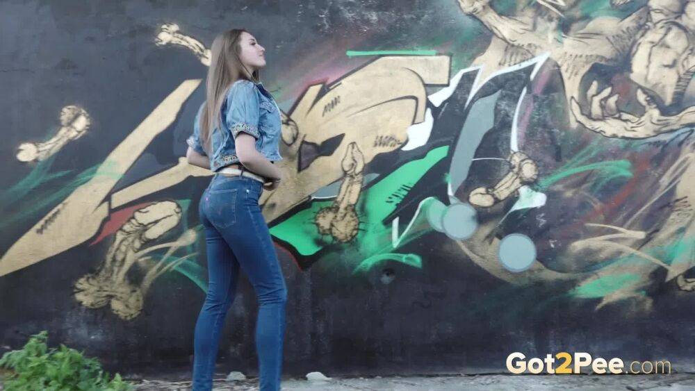 White girl Viktoria pulls down her jeans to take a pee near a wall of graffiti - #4