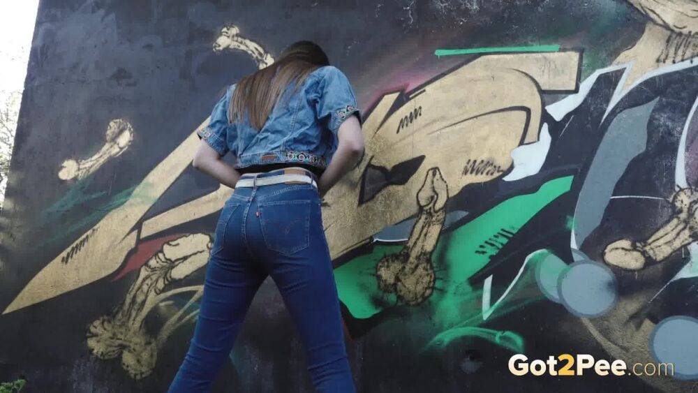 White girl Viktoria pulls down her jeans to take a pee near a wall of graffiti - #3