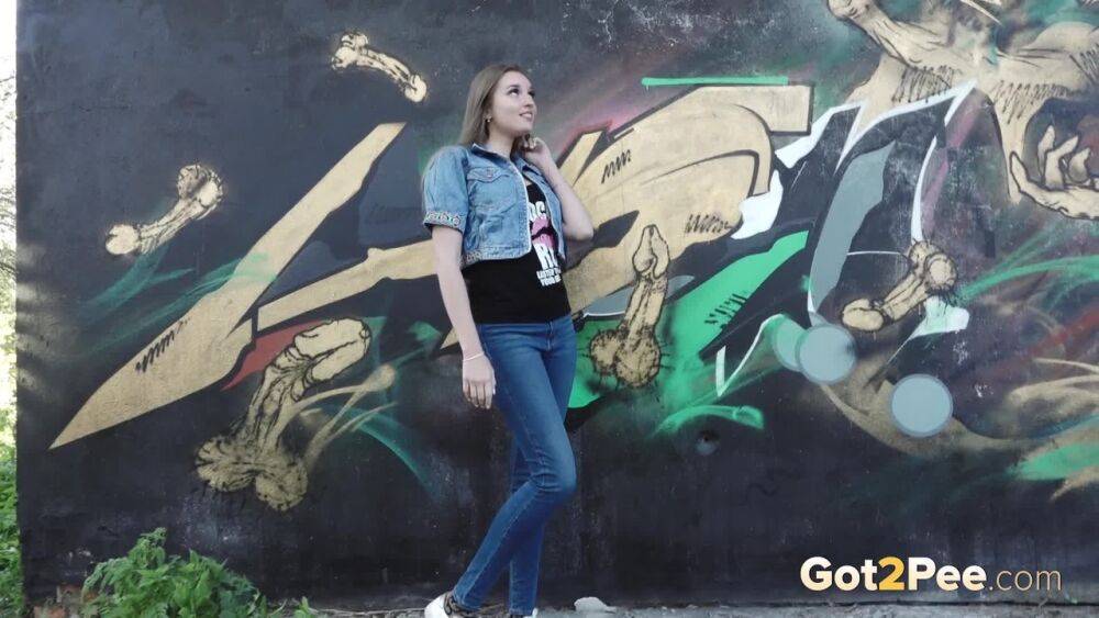 White girl Viktoria pulls down her jeans to take a pee near a wall of graffiti - #11