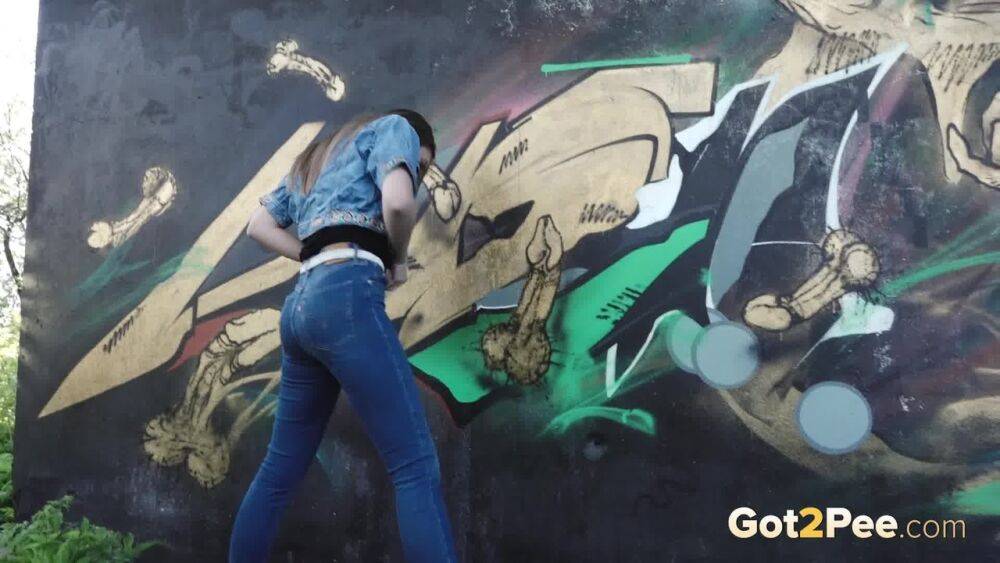 White girl Viktoria pulls down her jeans to take a pee near a wall of graffiti - #9