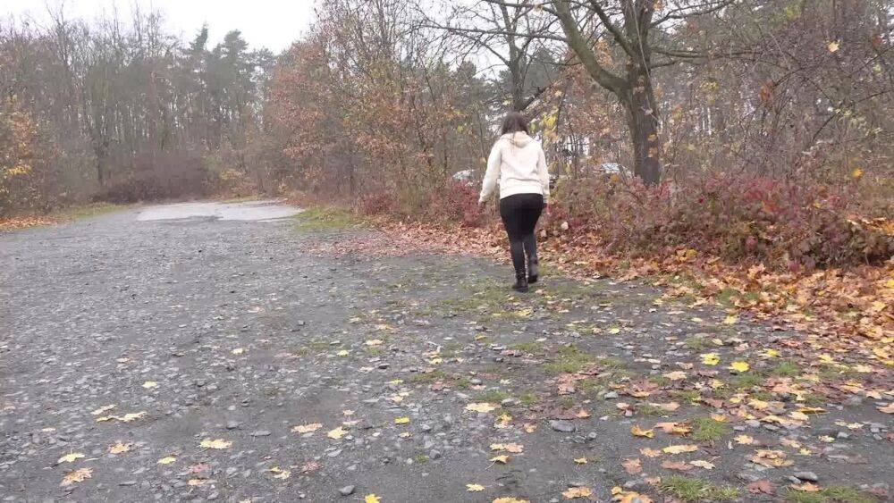 White girl Nicolette Noir takes a piss beside a parked car in a wooded setting - #13