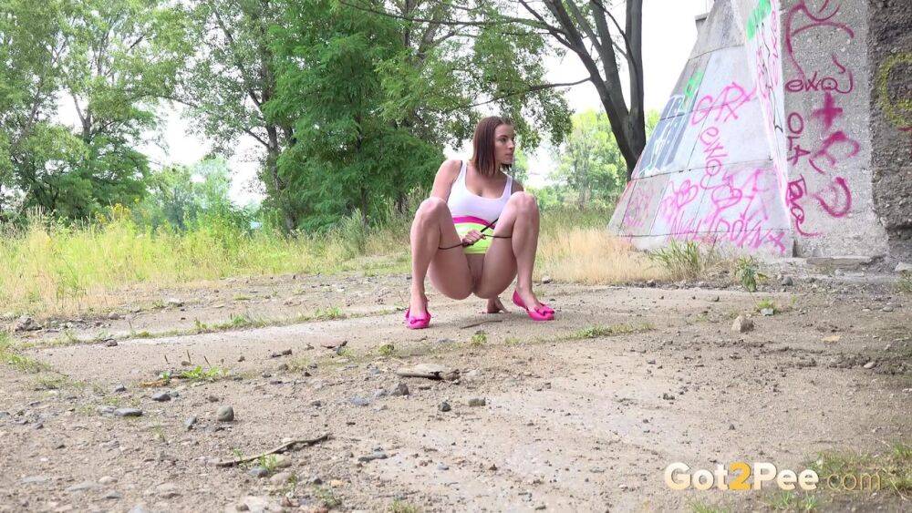 White girl Vicoria Daniels shows her bald cunt while pissing under an overpass - #6