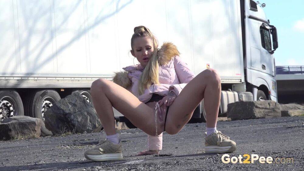 White girl Isabel Dark takes a piss on a gravel lot wear big rigs park - #15
