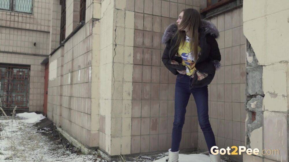 White girl Vika takes an urgent piss on snow-covered ground next to a building - #15