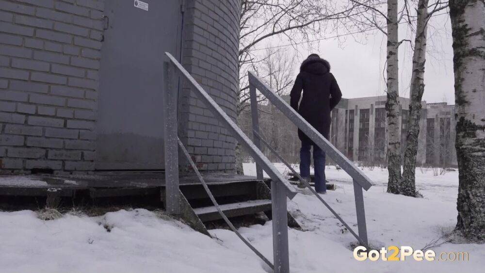 White girl pulls down her jeans to pee in the snow behind a building - #11