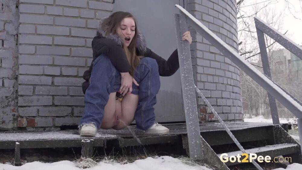 White girl pulls down her jeans to pee in the snow behind a building - #14