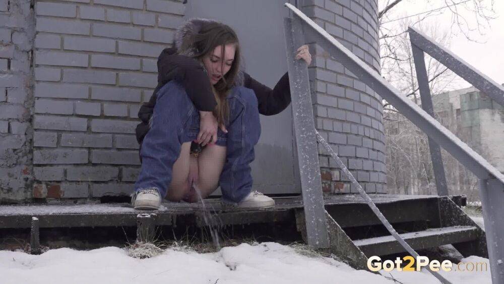 White girl pulls down her jeans to pee in the snow behind a building - #13