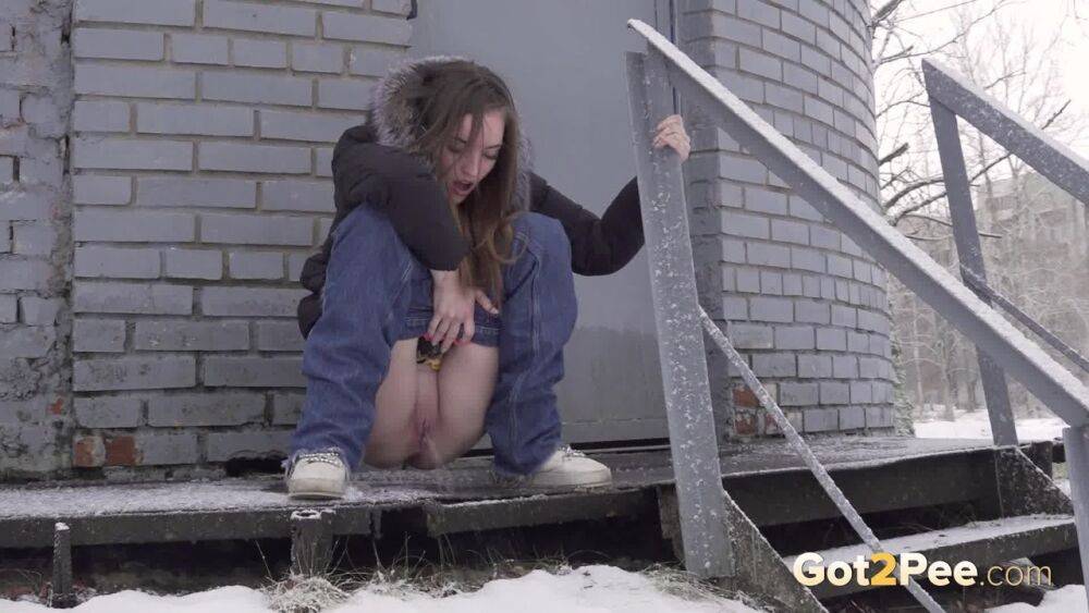 White girl pulls down her jeans to pee in the snow behind a building - #6