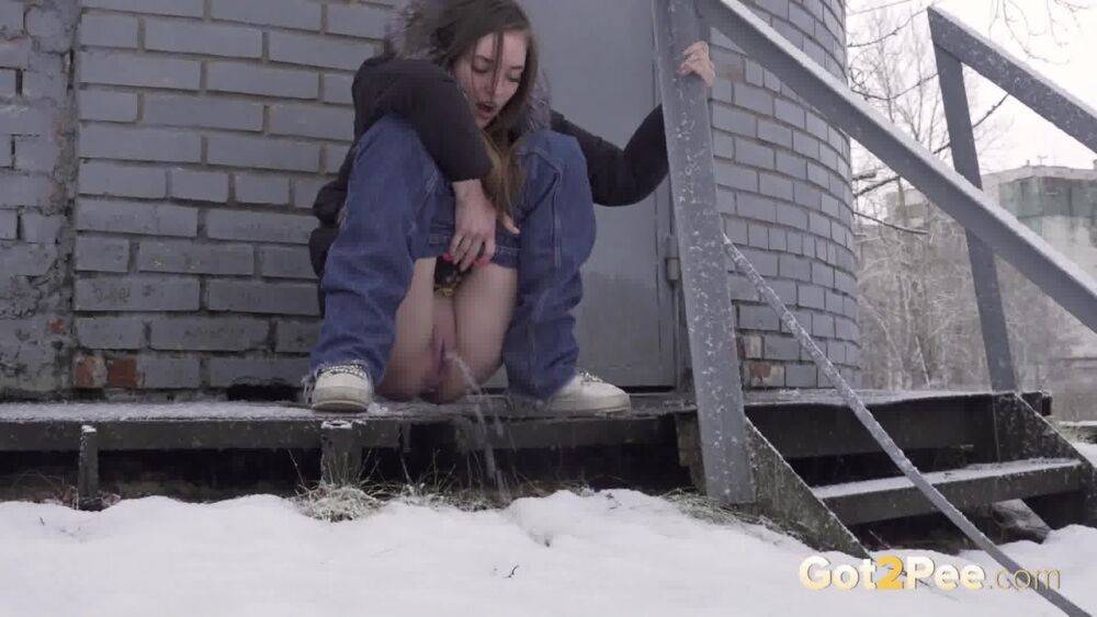 White girl pulls down her jeans to pee in the snow behind a building - #4