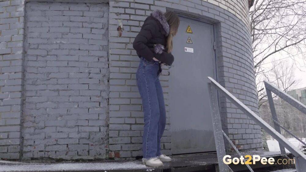 White girl pulls down her jeans to pee in the snow behind a building - #12
