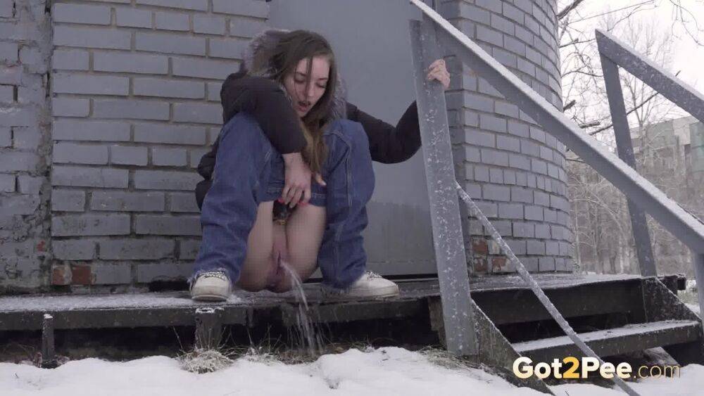 White girl pulls down her jeans to pee in the snow behind a building - #9