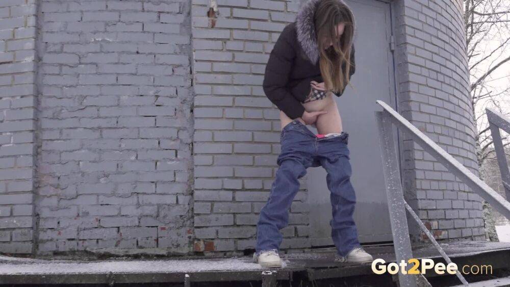 White girl pulls down her jeans to pee in the snow behind a building - #5