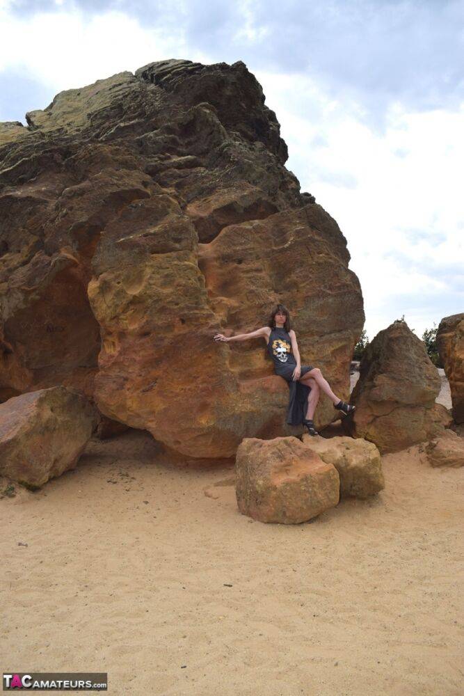 Amateur model exposes her vagina during upskirt action on rust stained rocks - #9