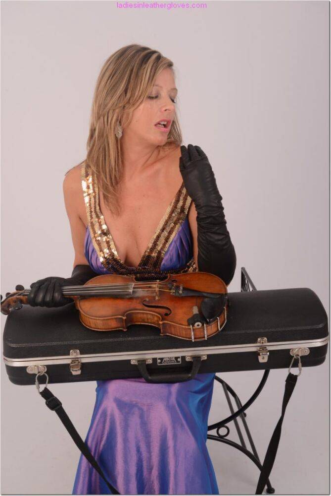 Sexy woman takes out her violin in an elegant dress and long leather gloves - #14