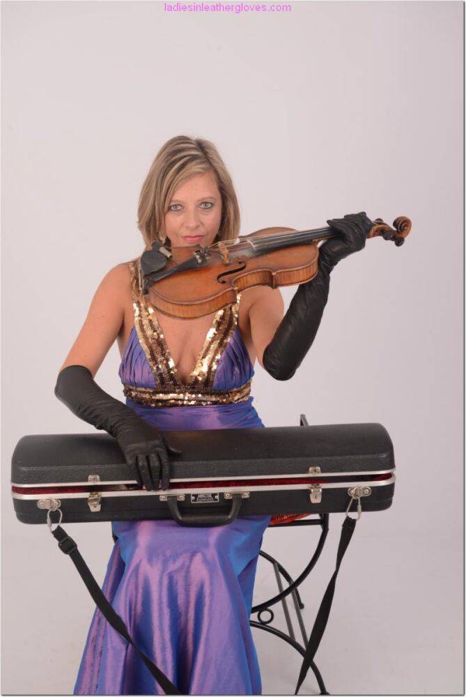 Sexy woman takes out her violin in an elegant dress and long leather gloves - #7