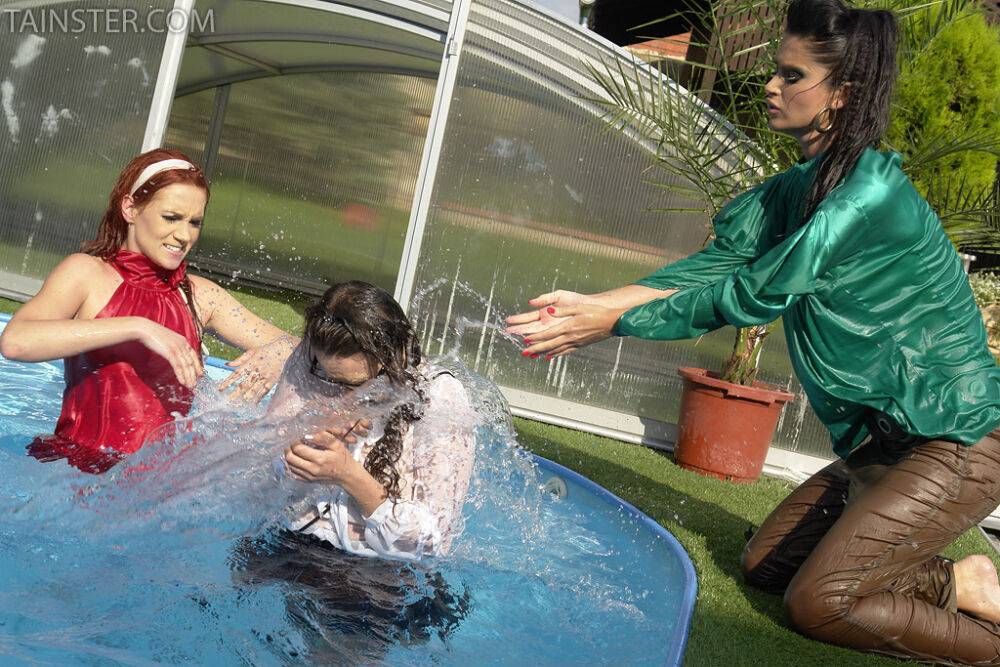 Clothed ladies jump into a pool before showing off their bare breasts - #12