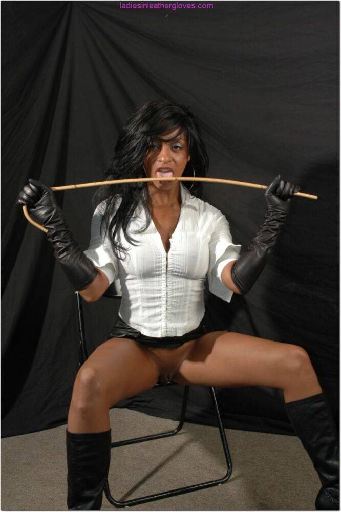 Ebony woman dons long leather gloves in a matching skirt and boots - #4