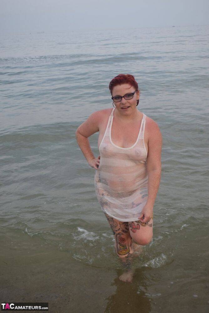 Tattooed redhead poses nude on a beach before masturbating on a toilet seat - #16