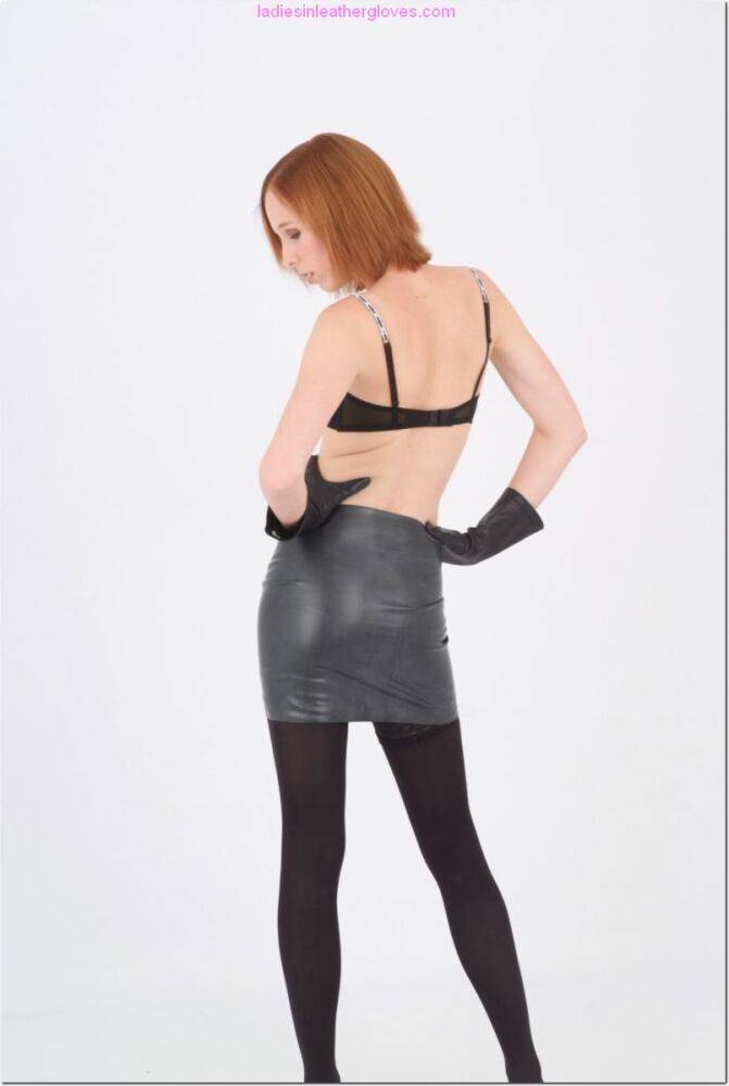 Natural redhead goes topless in a leather skirt and gloves with black hose - #5