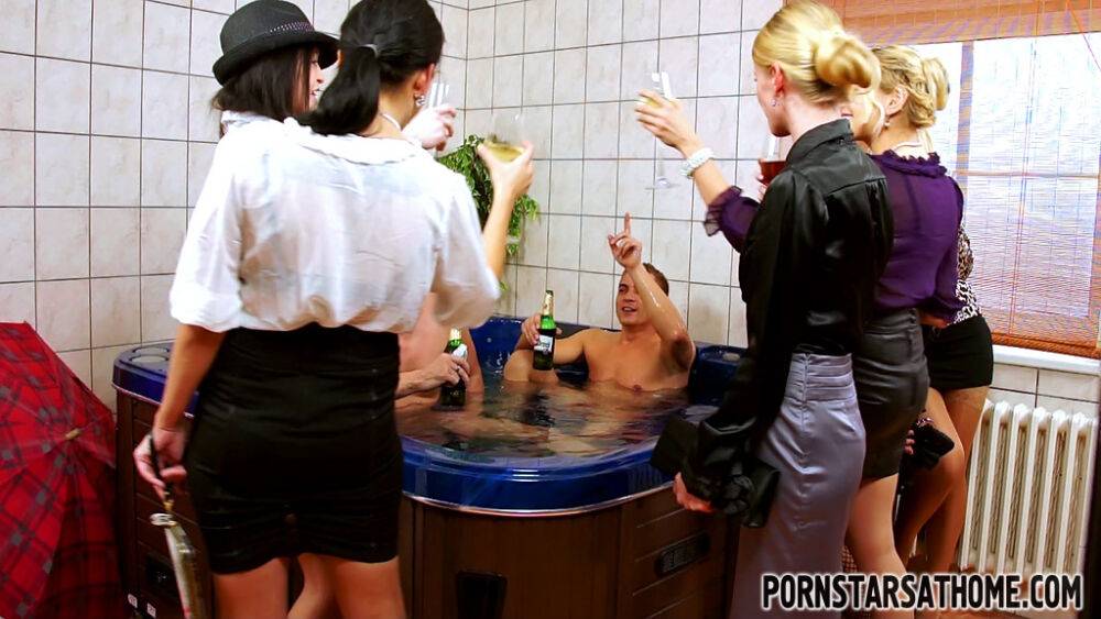 Clothed ladies join naked men in a hot tub for group sex fun and games - #10