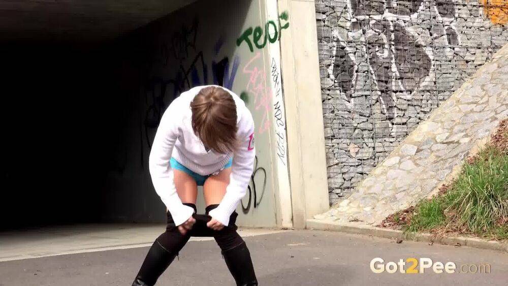 Short haired Shila in tall boots shows her shaved twat while peeing in public - #8