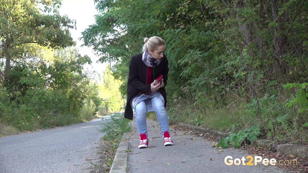 Pretty blonde Di Devi pulls down her jeans to pee on a public sidewalk - #11