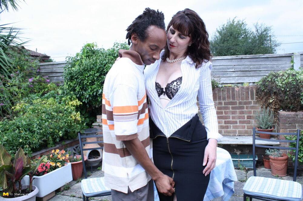 Cheating UK housewife seduces a black man in a black skirt on patio - #4