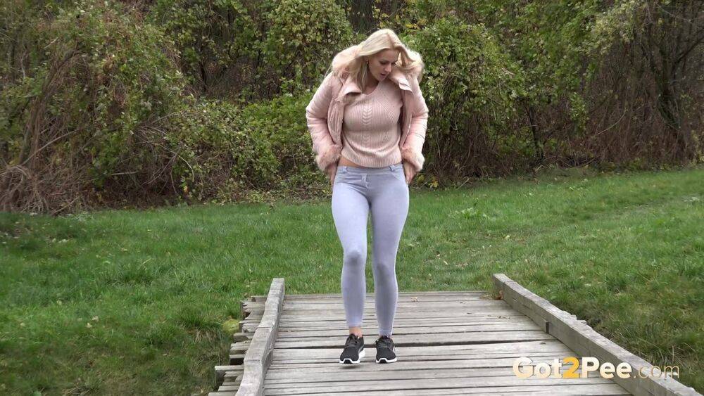 Blonde Katy Sky shows her bald beaver while squatting outside for a pee - #7