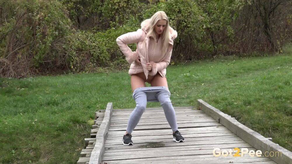 Blonde Katy Sky shows her bald beaver while squatting outside for a pee - #13