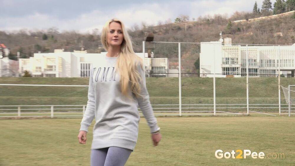 Blonde Katy Sky pisses next to a football field - #4