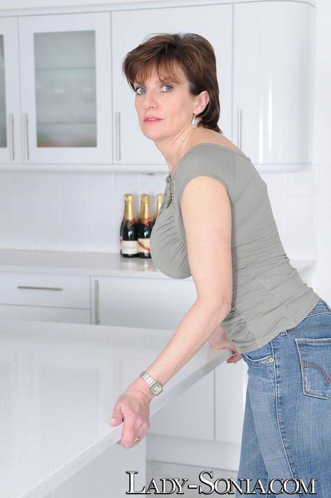 Mature wife Lady Sonia flaunts big tits braless in t-shirt in the kitchen - #5